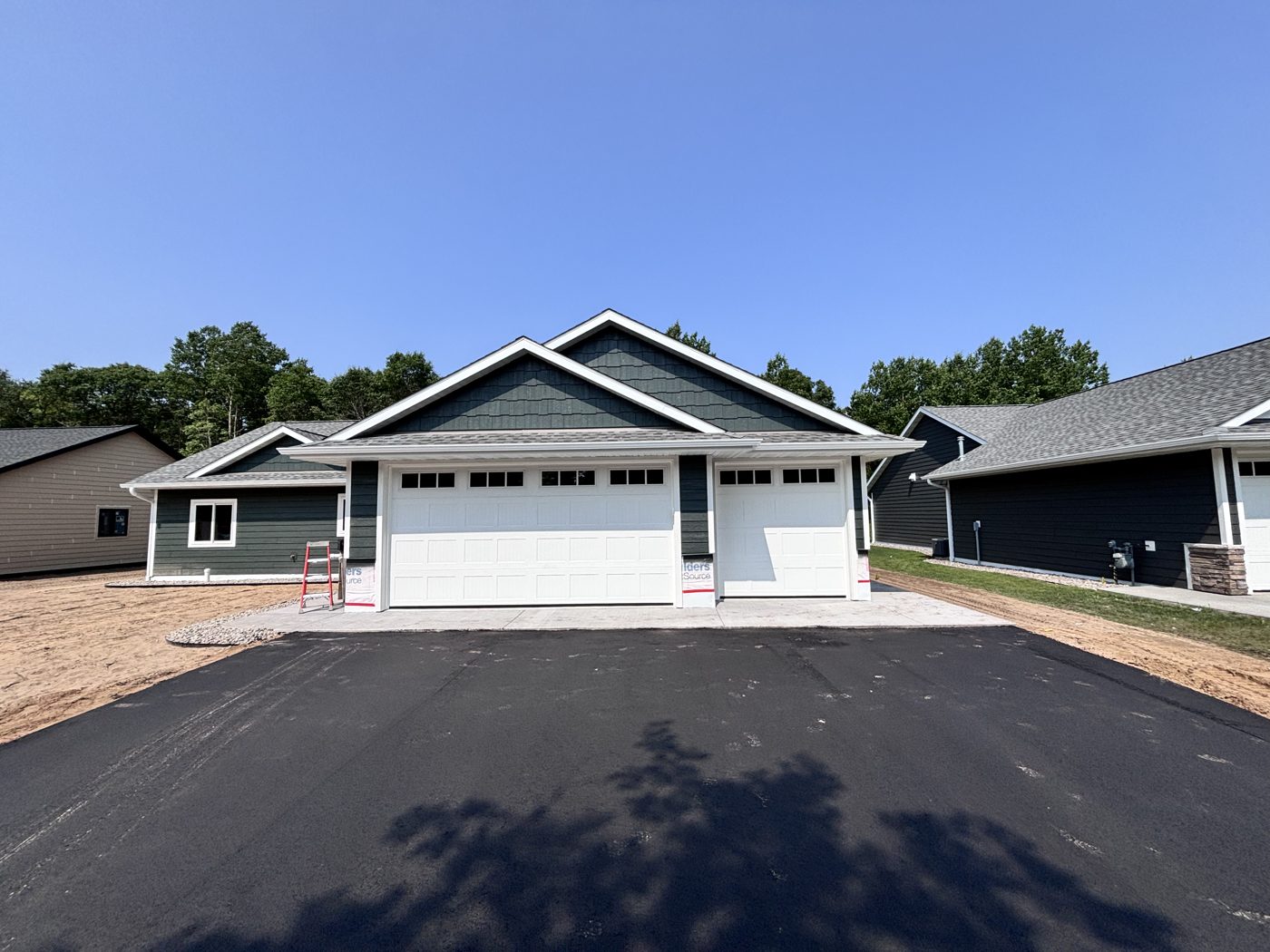 New white garage doors installed by Powell's Garage Door Services on a Brainerd Lakes Area home